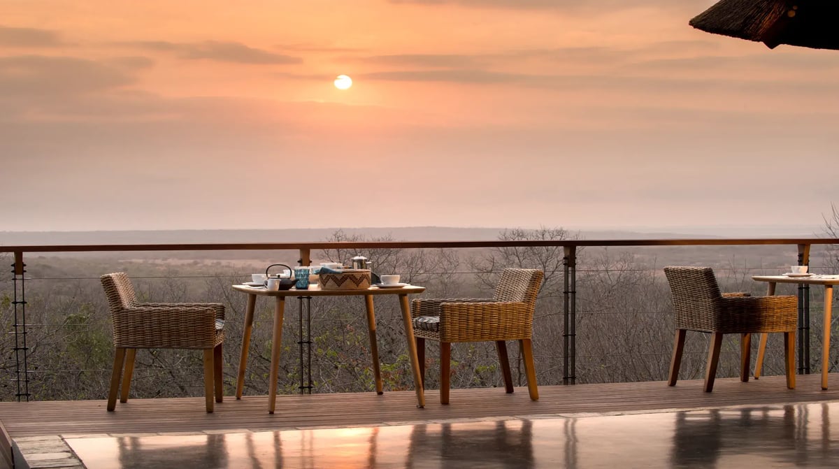 South Africa Phinda Mountain Lodge guest area dining on deck at sunrise