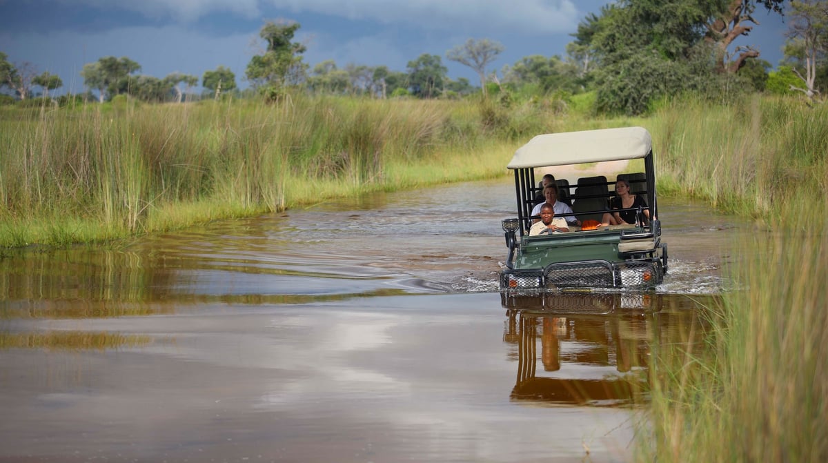 Botswana-andBeyondNxabega-Okavango-Delta-Camp-Experience-Game-Drive-vehcile-in-the-water