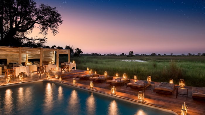 Botswana-andBeyondNxabega-Okavango-Tented-Camp-Guest-Area-Deck-dinner-at-the-pool