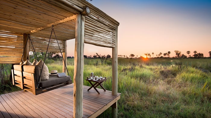 Botswana-andBeyondNxabega-Okavango-Tented-Camp-Tent-deck-and-swing-with-a-view