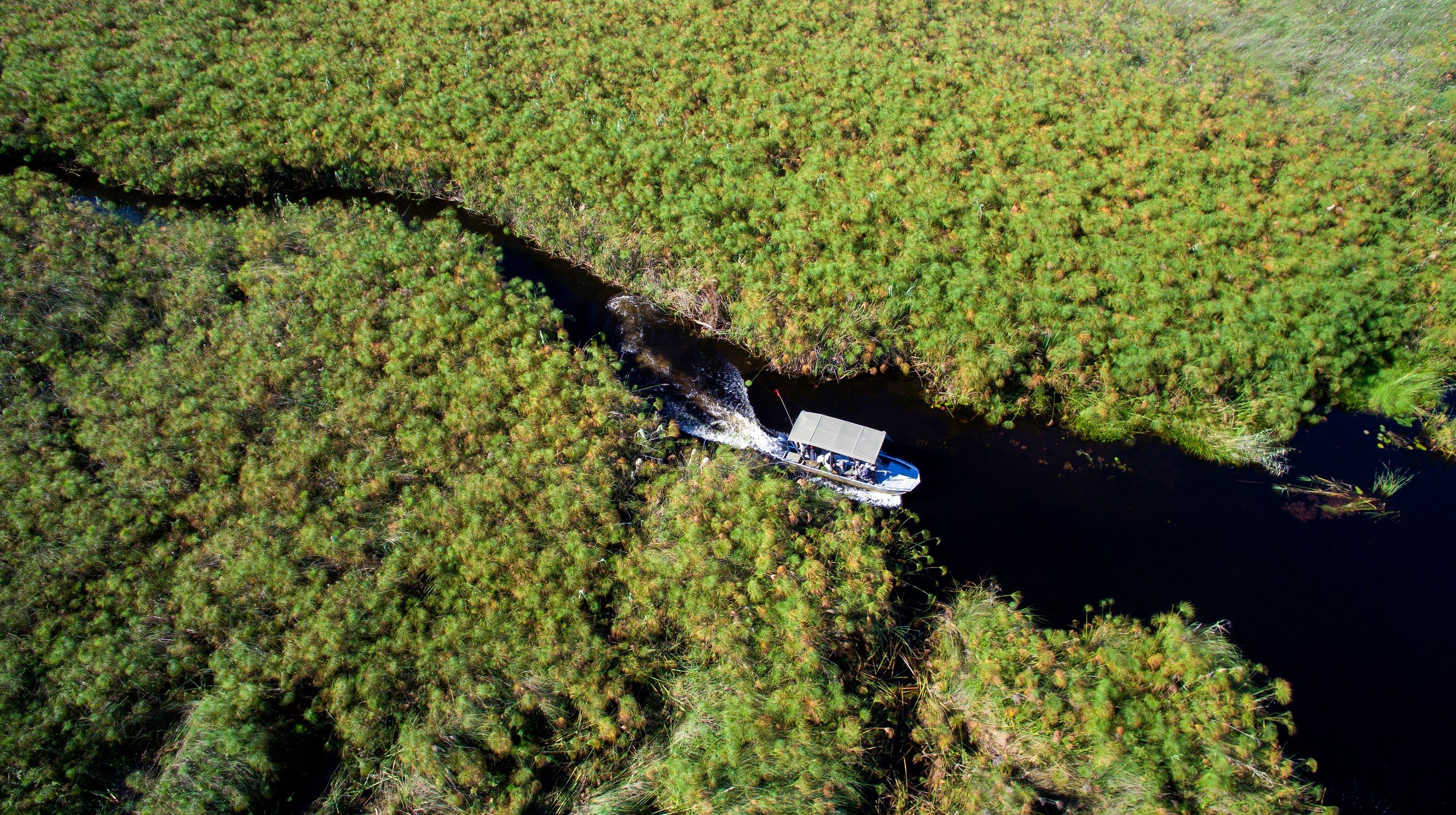 Botswana-andBeyondNxabega-Okavango-Tented-Camp-Aerial-view-of-boat-cruise
